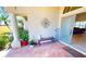 Inviting front porch with tiled flooring, decorative columns, cozy seating, and a 'Home Sweet Home' welcome sign at 569 Royal Poinciana, Punta Gorda, FL 33955