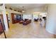 A living room with tile floors seamlessly connects to the dining area, creating a warm and inviting gathering space at 569 Royal Poinciana, Punta Gorda, FL 33955