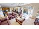 Open-concept living room with leather furniture and sliding glass doors to the pool at 569 Royal Poinciana, Punta Gorda, FL 33955