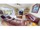 Comfortable living room with built-in shelving, plush seating, and pool view at 569 Royal Poinciana, Punta Gorda, FL 33955