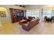 The living room features a media center, comfortable sofas, and views of the backyard pool area at 569 Royal Poinciana, Punta Gorda, FL 33955