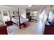 Spacious primary bedroom features a four-poster bed, ensuite bathroom access, and backyard views at 569 Royal Poinciana, Punta Gorda, FL 33955