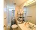 Cozy bathroom featuring a shower, toilet, sink, and mirror at 6821 Ocean Ct # Lot 30, North Port, FL 34287