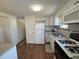 Bright kitchen with white cabinets and appliances, and granite countertops at 6821 Ocean Ct # Lot 30, North Port, FL 34287