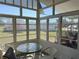 Enclosed porch featuring multiple windows, outdoor views, and seating at 6821 Ocean Ct # Lot 30, North Port, FL 34287