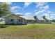 Inviting home exterior boasting a well-maintained lawn and a cozy front porch at 7055 Riverside Dr, Punta Gorda, FL 33982