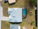 Aerial view of single-Gathering home with backyard pool, private dock, metal roof and detached garage at 908 Tropical Nw Cir, Port Charlotte, FL 33948