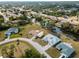Beautiful aerial view of a subdivision on the water with lush trees, canals, and single Gathering homes at 908 Tropical Nw Cir, Port Charlotte, FL 33948