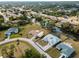 Stunning aerial view of a residential neighborhood with canal access and lush greenery at 908 Tropical Nw Cir, Port Charlotte, FL 33948