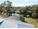 Backyard view featuring a screened pool enclosure and canal access with private dock at 908 Tropical Nw Cir, Port Charlotte, FL 33948