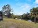 Expansive backyard featuring a canal with private docks and lush tropical landscaping at 908 Tropical Nw Cir, Port Charlotte, FL 33948