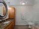 Bathroom features a walk-in shower, granite countertop, and wooden vanity with ample space at 908 Tropical Nw Cir, Port Charlotte, FL 33948