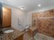 Bathroom featuring a walk-in shower, granite countertop, and wooden vanity at 908 Tropical Nw Cir, Port Charlotte, FL 33948