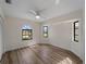 Bedroom features wood floors, multiple windows, and plenty of bright, open space at 908 Tropical Nw Cir, Port Charlotte, FL 33948