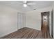 Bedroom showcases wood floors, a closet with louvered doors, and plenty of space at 908 Tropical Nw Cir, Port Charlotte, FL 33948