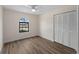 Bedroom features wood floors, closet with louvered doors, and an arched window at 908 Tropical Nw Cir, Port Charlotte, FL 33948