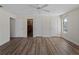Bright bedroom featuring wood floors, ceiling fan, and access to closets at 908 Tropical Nw Cir, Port Charlotte, FL 33948