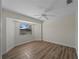 Bedroom with wood floors, a window nook, and ample space for relaxation at 908 Tropical Nw Cir, Port Charlotte, FL 33948
