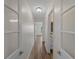 Hallway featuring light walls, modern doors, and plank flooring at 908 Tropical Nw Cir, Port Charlotte, FL 33948