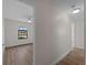A hallway with doors and views of the bedrooms and natural light streaming from the windows at 908 Tropical Nw Cir, Port Charlotte, FL 33948