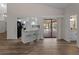 Open concept kitchen with modern white cabinetry, stainless appliances, bar seating, and access to the patio at 908 Tropical Nw Cir, Port Charlotte, FL 33948