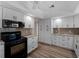 Contemporary kitchen featuring white cabinets, granite countertops, and modern appliances at 908 Tropical Nw Cir, Port Charlotte, FL 33948