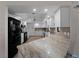 Spacious kitchen with white cabinetry, granite countertops, and modern black appliances at 908 Tropical Nw Cir, Port Charlotte, FL 33948