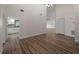 Bright living room showcasing new hardwood floors, fresh paint, and an arched entryway to the kitchen at 908 Tropical Nw Cir, Port Charlotte, FL 33948