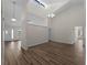 Open-concept living area with skylight, plank flooring, and neutral colored walls at 908 Tropical Nw Cir, Port Charlotte, FL 33948