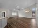 Spacious living room with wood floors, a high ceiling, and natural light from clerestory window at 908 Tropical Nw Cir, Port Charlotte, FL 33948