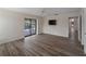 Spacious living room with wood floors and sliding door access to the pool area at 908 Tropical Nw Cir, Port Charlotte, FL 33948