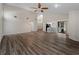 Bright open-concept living area with wood floors, high ceilings, and plenty of natural light at 908 Tropical Nw Cir, Port Charlotte, FL 33948