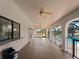 Covered patio with a built-in bar area, brick flooring, and views of the pool and yard at 908 Tropical Nw Cir, Port Charlotte, FL 33948