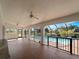 Spacious screened-in patio with brick floors, ceiling fans, and views of the pool at 908 Tropical Nw Cir, Port Charlotte, FL 33948