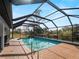 Relaxing screened-in pool surrounded by lush greenery and views of the canal at 908 Tropical Nw Cir, Port Charlotte, FL 33948