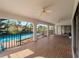 An expansive covered patio with ceiling fans overlooks the inviting pool and verdant backyard at 908 Tropical Nw Cir, Port Charlotte, FL 33948