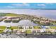 Panoramic aerial shot of waterfront community with homes and condos around a lake at 103 Colony Point Dr, Punta Gorda, FL 33950