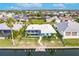 Aerial view of a waterfront home with a screened-in pool and tropical landscaping at 103 Colony Point Dr, Punta Gorda, FL 33950