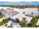 Aerial view of a white home with a blue garage door overlooking a tranquil lake at 103 Colony Point Dr, Punta Gorda, FL 33950