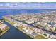 Aerial view showcases a large waterfront community, canals, and residential properties at 103 Colony Point Dr, Punta Gorda, FL 33950
