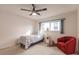 Cozy bedroom with a red accent chair, ceiling fan, and large window at 103 Colony Point Dr, Punta Gorda, FL 33950