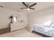 Bright bedroom features a ceiling fan and a white dresser with decorative mirror at 103 Colony Point Dr, Punta Gorda, FL 33950