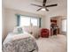 Bright bedroom features a ceiling fan, a large window, and carpeted floors at 103 Colony Point Dr, Punta Gorda, FL 33950