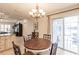 Dining area with a chandelier, a table with seating for four and sliding glass doors to patio at 103 Colony Point Dr, Punta Gorda, FL 33950