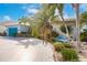 Charming home with lush tropical landscaping, mature palm trees and custom concrete driveway at 103 Colony Point Dr, Punta Gorda, FL 33950
