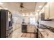 Kitchen with stainless steel appliances, granite counters, tile flooring, and adjacent dining area at 103 Colony Point Dr, Punta Gorda, FL 33950