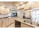 Kitchen with stainless steel appliances, granite counters, tile flooring, and adjacent dining area at 103 Colony Point Dr, Punta Gorda, FL 33950