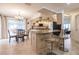 Open kitchen and dining area with granite counters, stainless appliances, and tile flooring at 103 Colony Point Dr, Punta Gorda, FL 33950