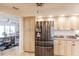 Kitchen area featuring stainless steel refrigerator and wood cabinets with granite countertops at 103 Colony Point Dr, Punta Gorda, FL 33950