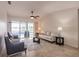 Bright living room featuring neutral tones, tile flooring, and sliding glass doors that lead to the outdoor space at 103 Colony Point Dr, Punta Gorda, FL 33950